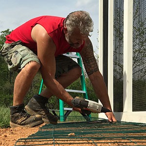 Carolina-Coops-installing a predator apron